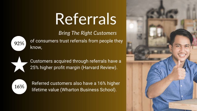 Man seated at a table giving thumbs up sign