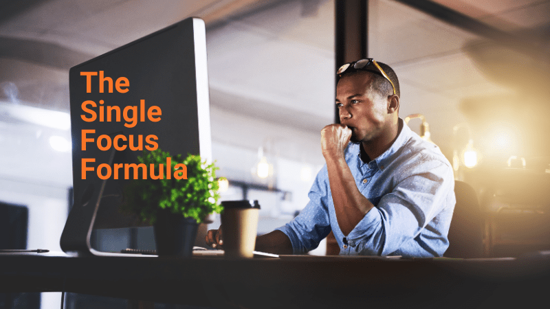 Single focus formula Man sitting at a desk with a single focus on his computer
