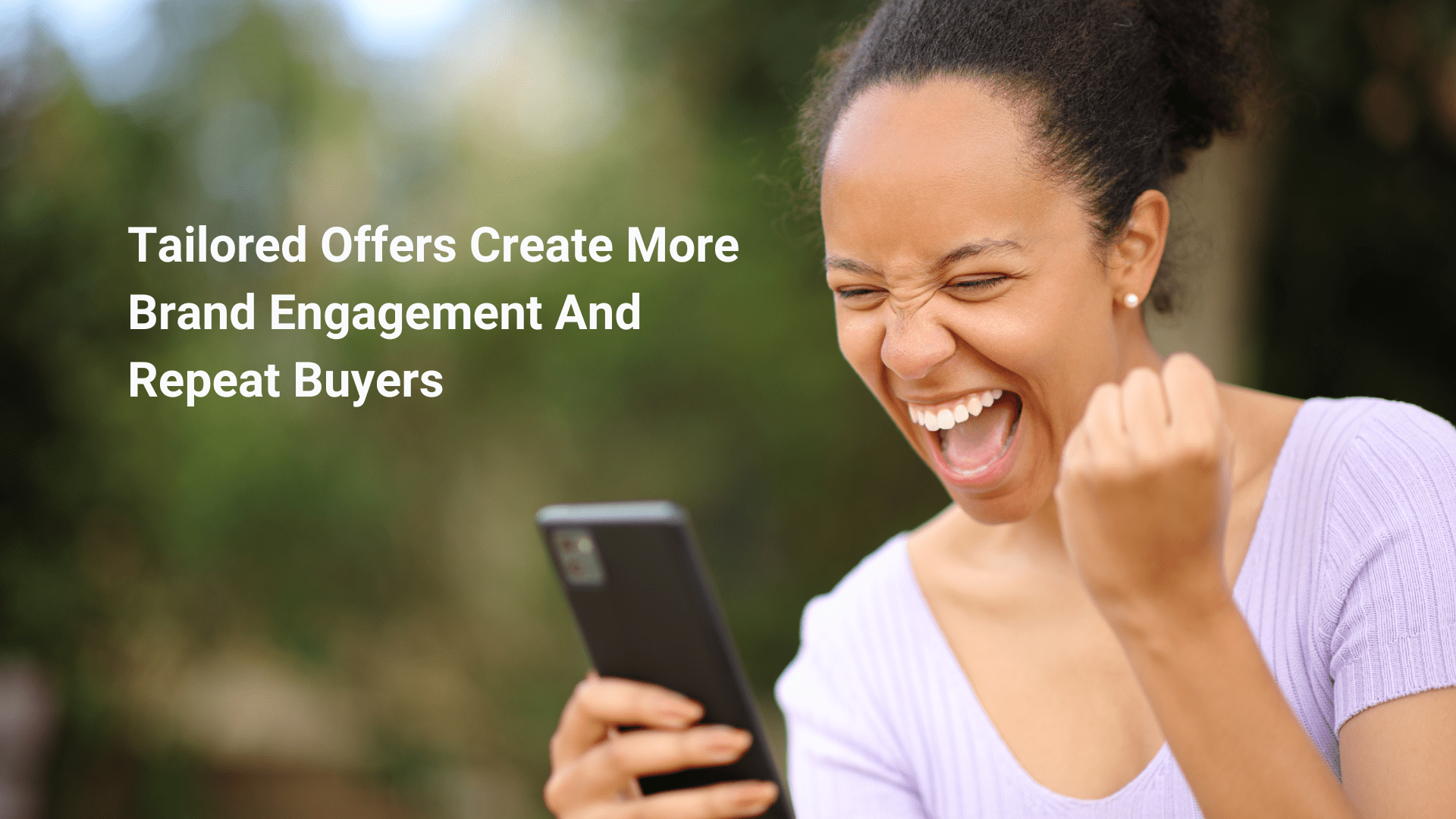 A lady looking at her phone very exited by hyper personalisation marketing 